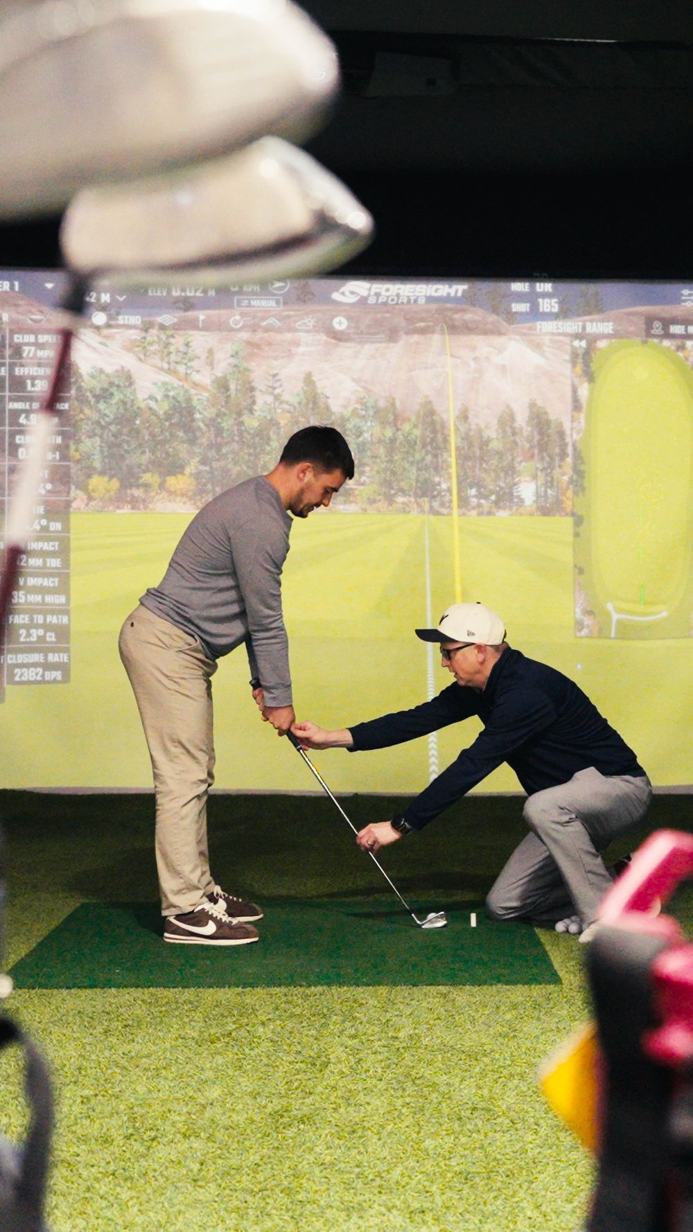A golf lesson in the simulator at Golf Warehouse